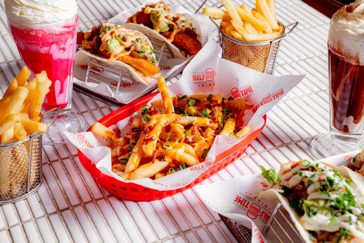 Diner spread of fries, tacos and shakes