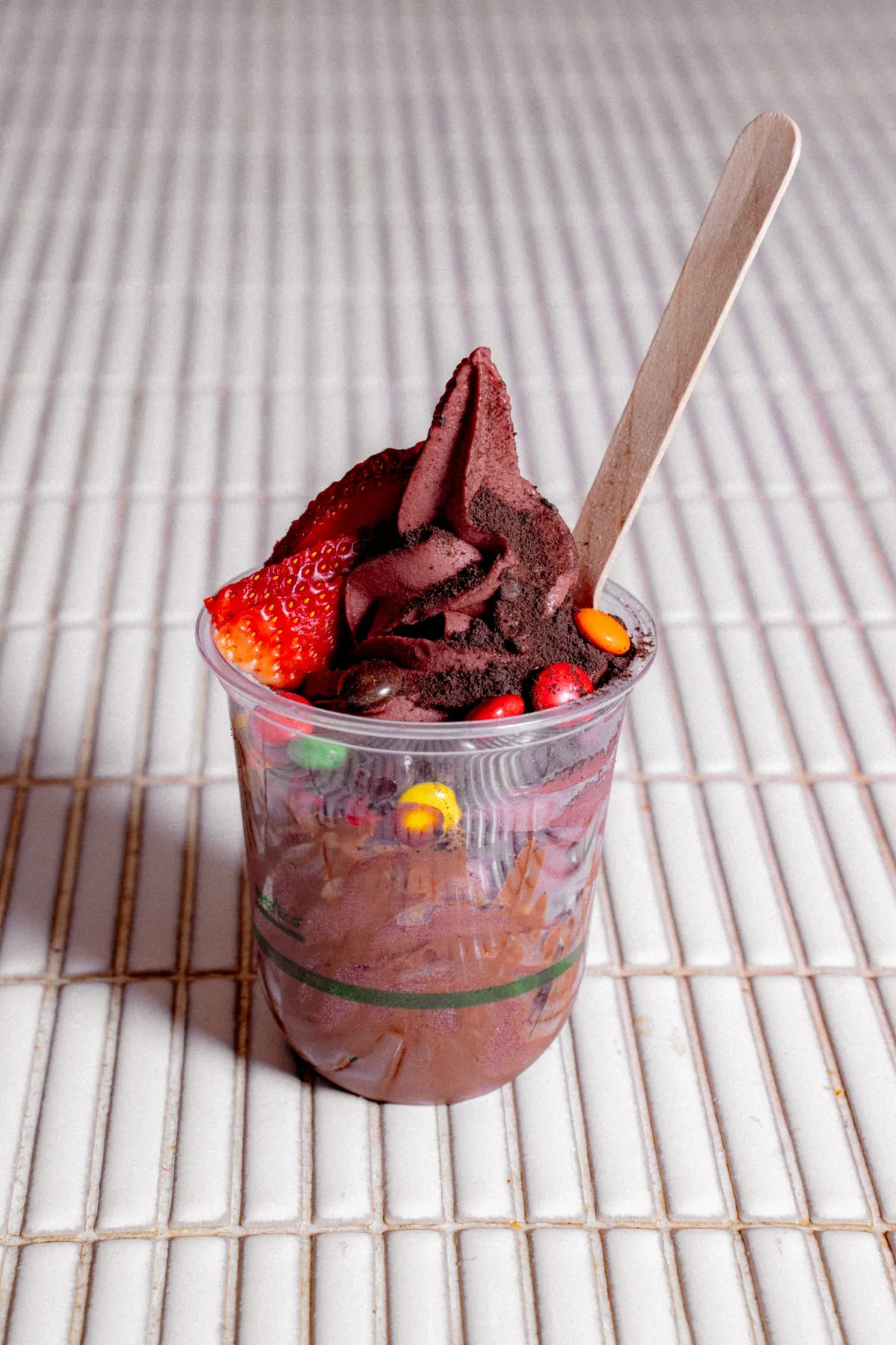 Chocolate soft-serve with strawberries and sprinkles