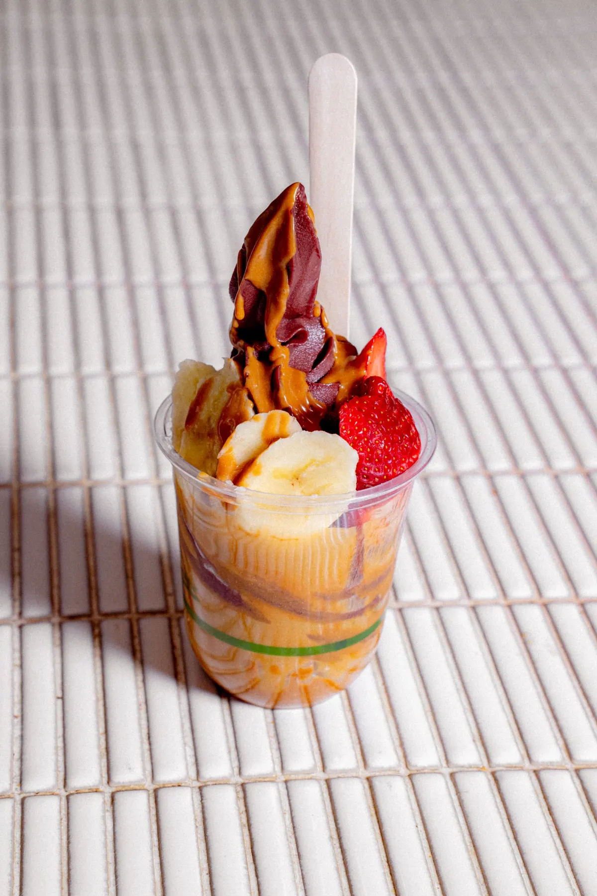 Caramel soft-serve sundae with banana and strawberries