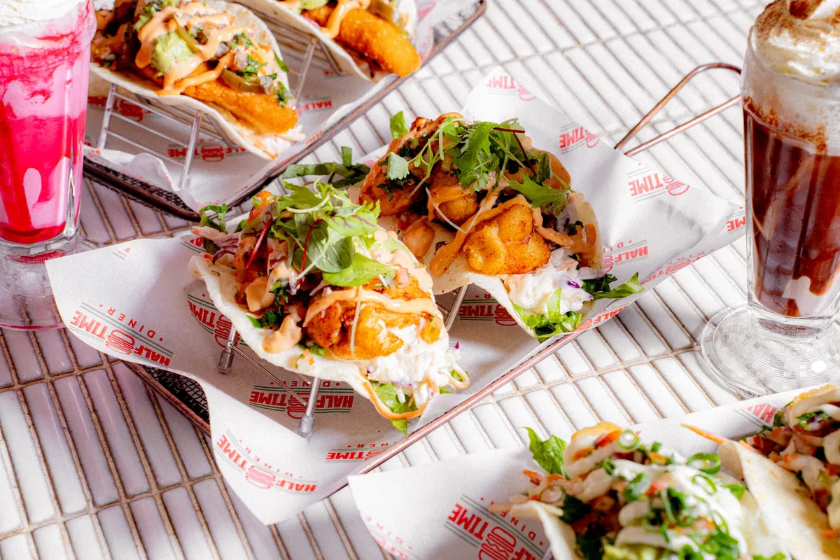 Fish tacos and fries with a strawberry milkshake