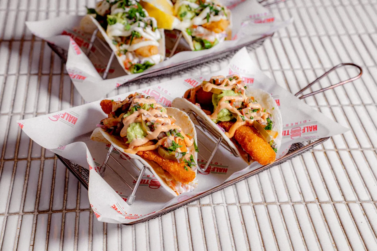 Tacos lined up in a metal holder