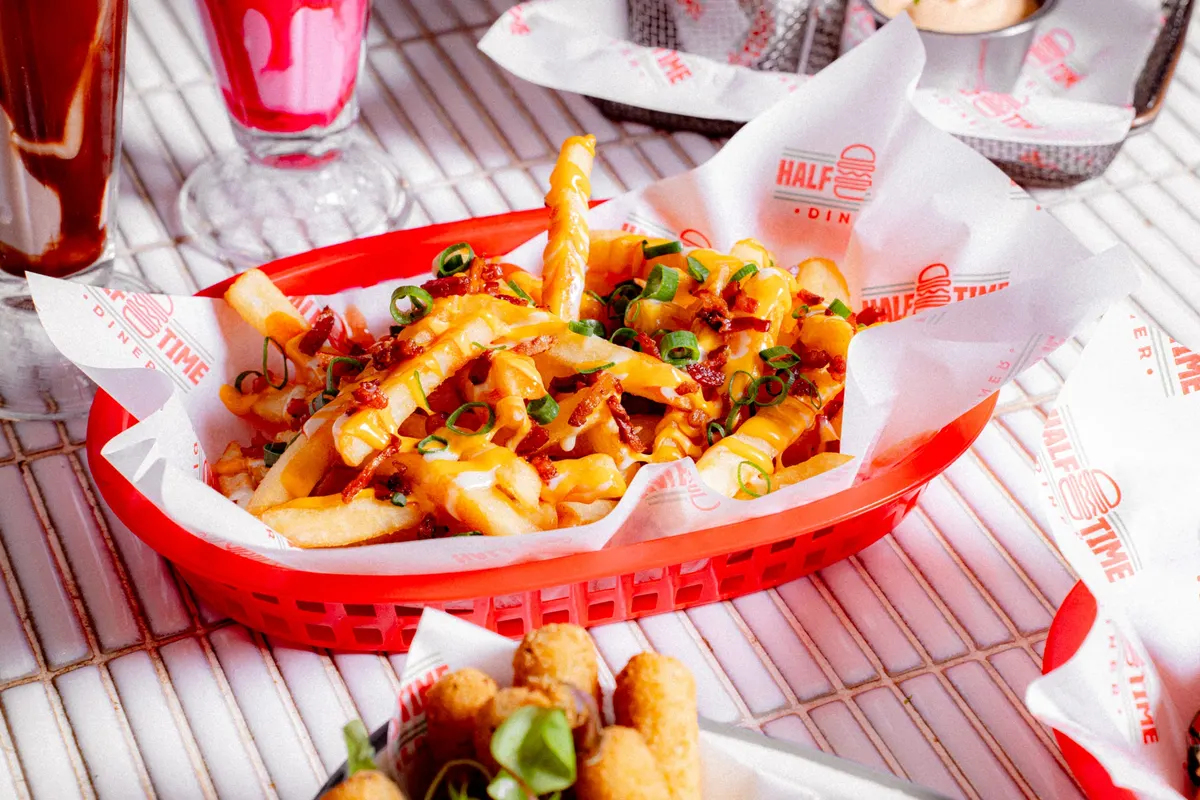 Loaded fries in a red diner basket